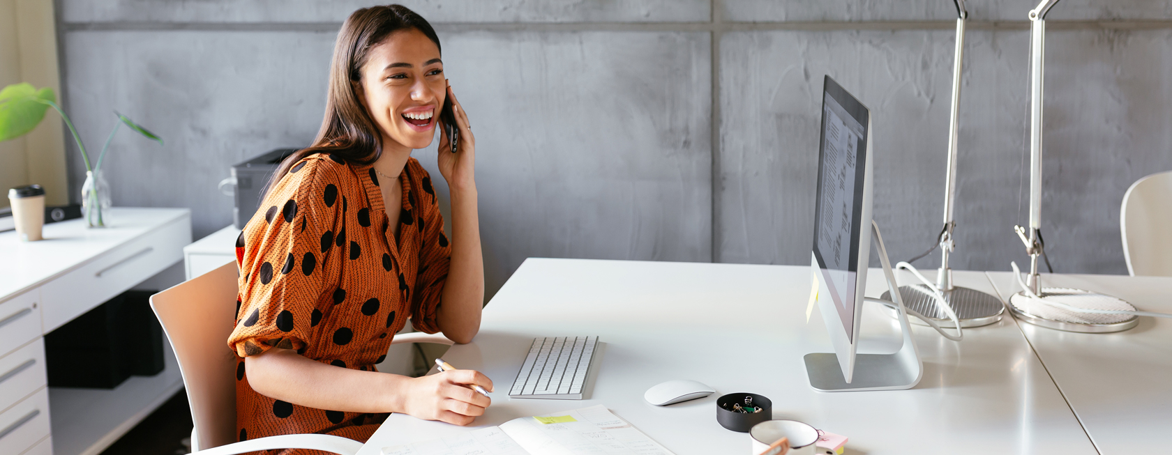 Smiling woman at desk.